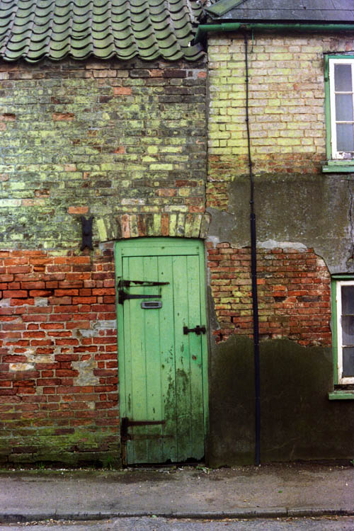 green_door_brick_wall_wrk